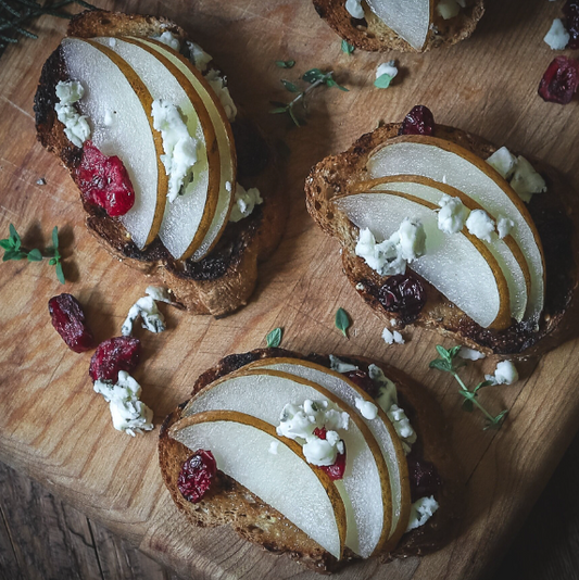 Pomegranate-Pear Crostini with Vines & Groves Fig Jam and Balsamic Drizzle